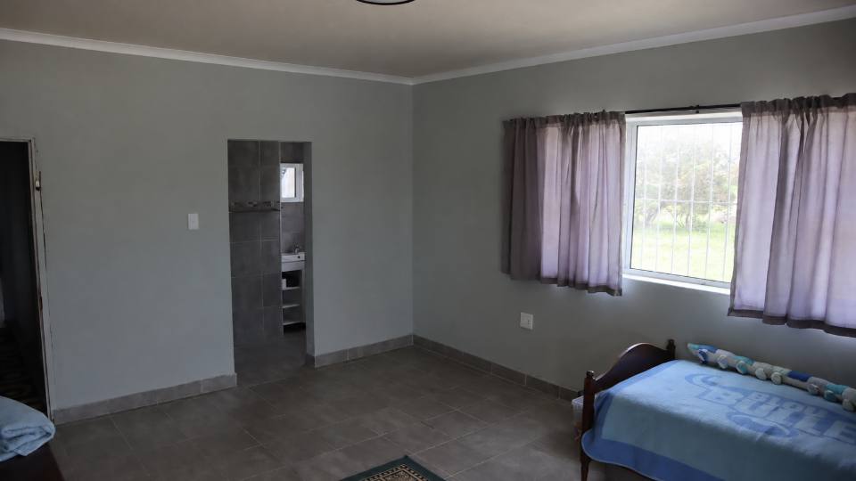 A bedroom with a doorway through to a shower room