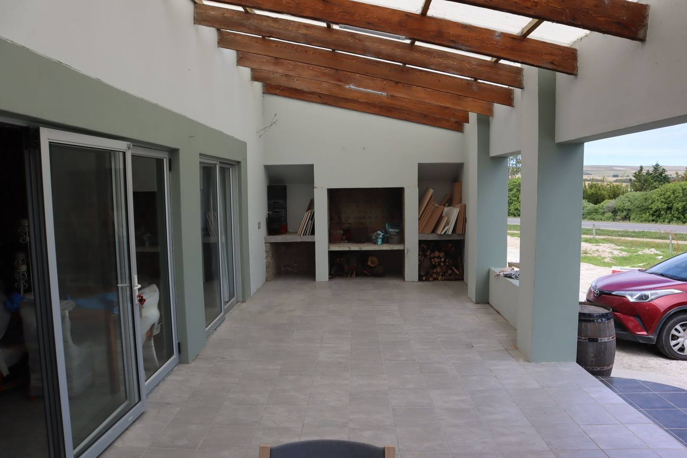 The built-in outside braai at the end of the patio, with a view across the road to the hills
