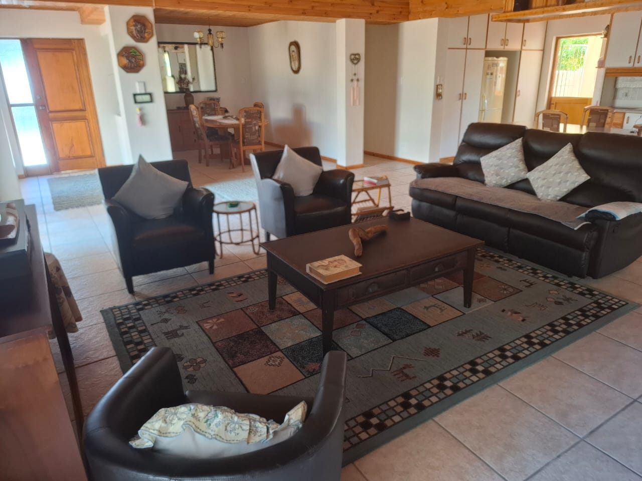 Leather couches and a coffee table on a patterned rug in the lounge