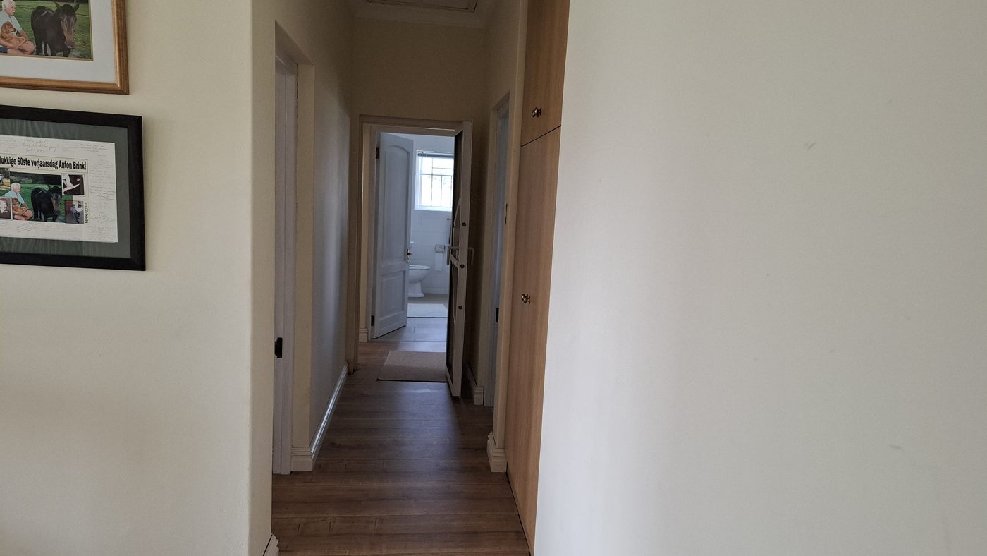 The passage, with a wooden floor and doors on both sides